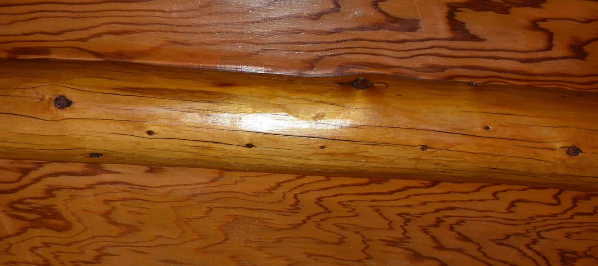 Close up view of cabin siding with a wooden log and boards