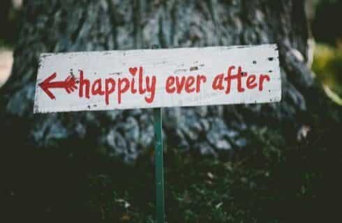 White wooden sign with happily ever after painted in red